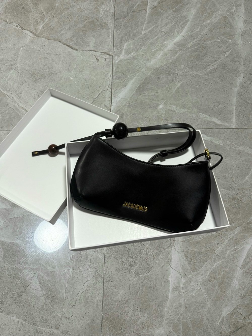 Sleek Black Leather Shoulder Bag with Beaded Strap Accent